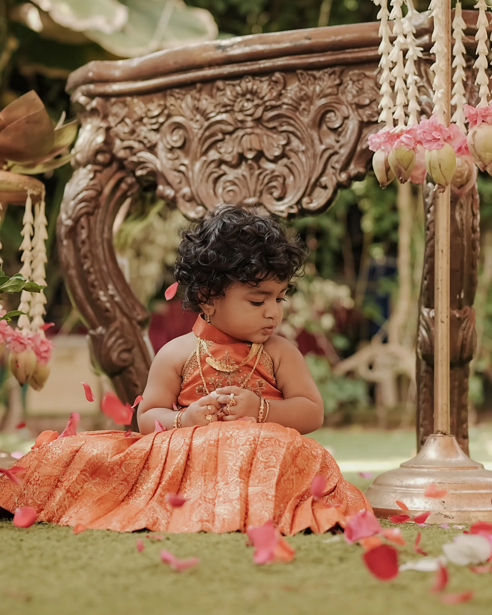 A baby beneath the cradle at her namakarana naming ceremony