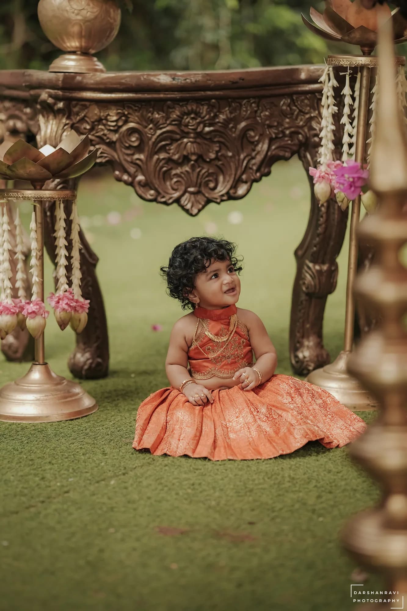 A baby beneath the cradle at her naming ceremony — Darshan Ravi Photography