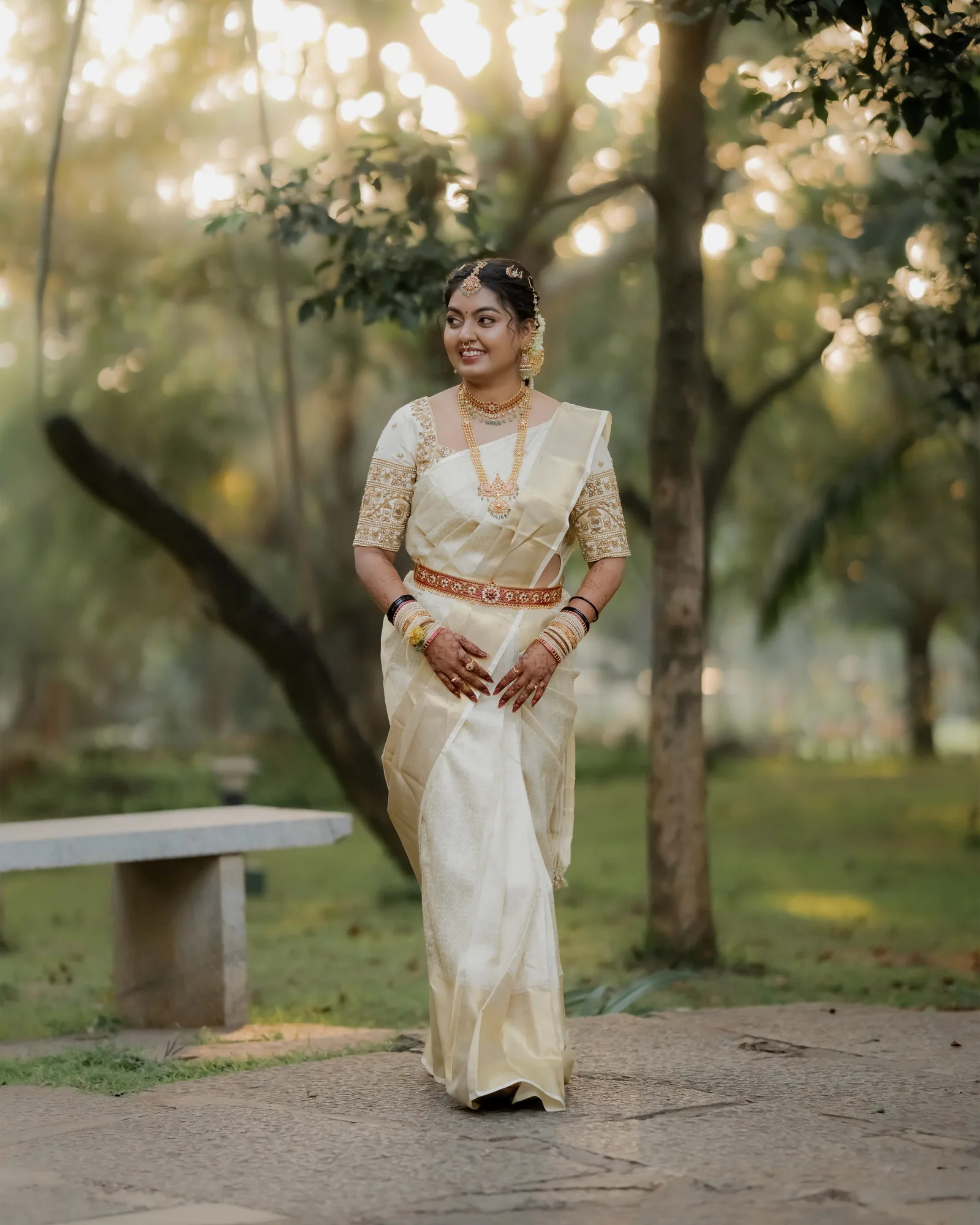 A bride in a cream silk saree at golden hour — Darshan Ravi Photography