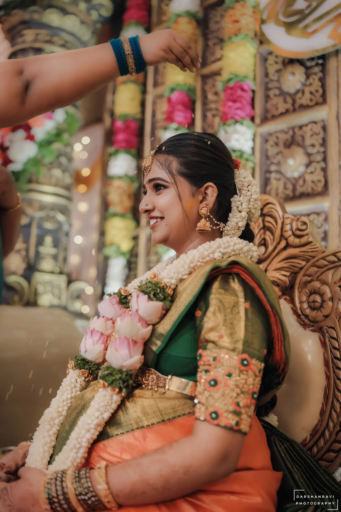 A bride garlanded during the ceremony — Darshan Ravi Photography